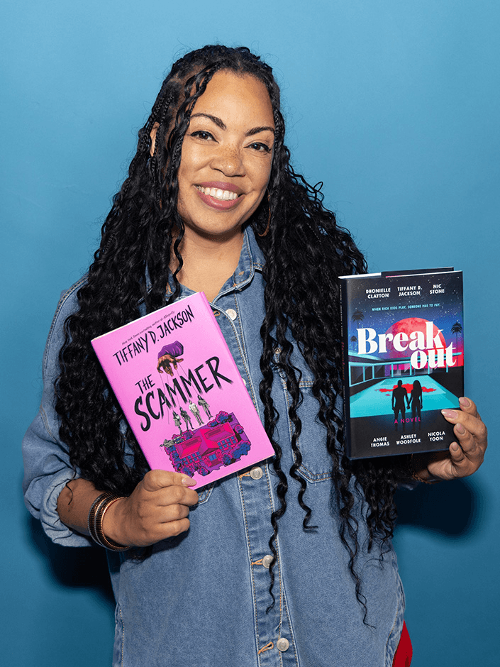 Tiffany D. Jackson holding copies of The Scammer and Breakout