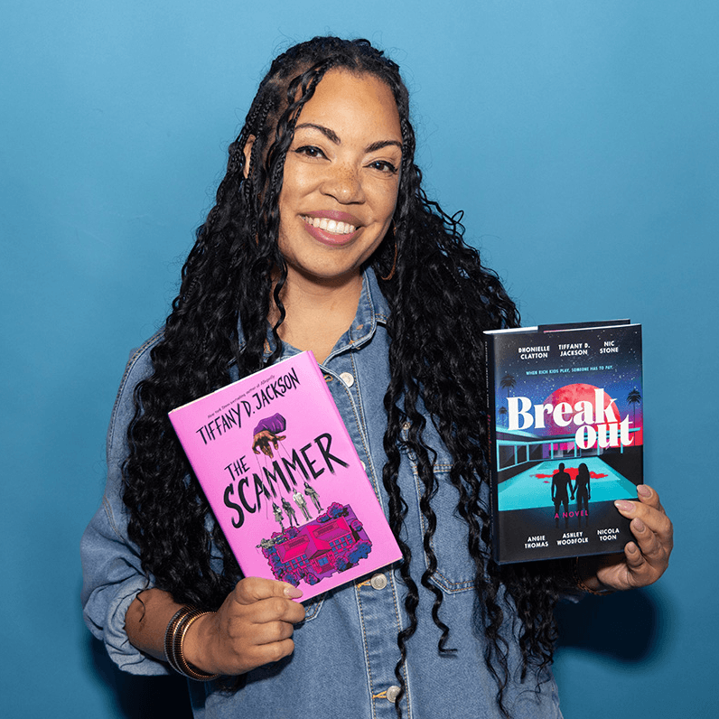 Tiffany D. Jackson holding copies of The Scammer and Breakout